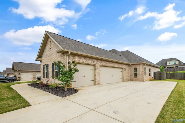 view of property exterior featuring fence, a shingled roof, an attached garage, brick siding, and driveway