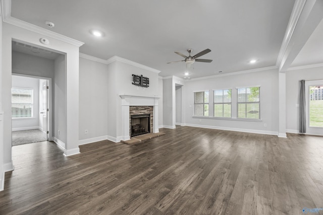 unfurnished living room featuring ceiling fan, dark wood finished floors, a stone fireplace, recessed lighting, and baseboards