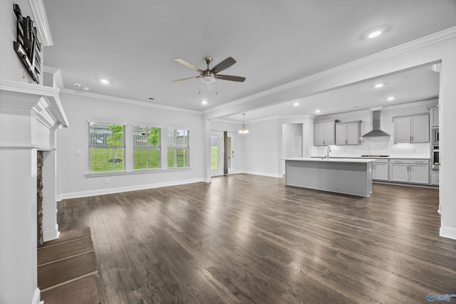 unfurnished living room with a fireplace, a ceiling fan, baseboards, recessed lighting, and dark wood-type flooring