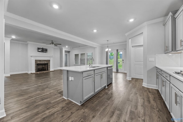 kitchen featuring stainless steel dishwasher, a sink, gray cabinets, and a ceiling fan