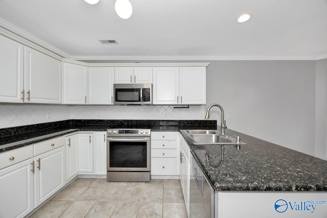 114 Canterbury Dr, Madison, AL 35758 - kitchen with stainless steel appliances, a peninsula, ornamental molding, white cabinetry, and backsplash