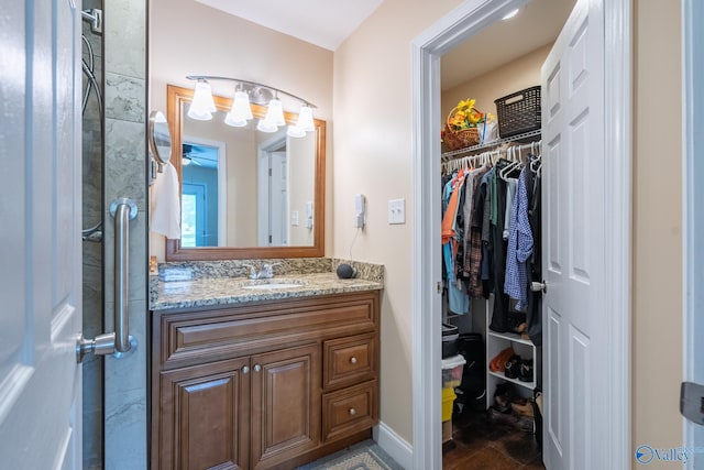 915 County Road 349, Leesburg, AL 35983 - bathroom featuring a spacious closet, baseboards, a shower with door, and vanity