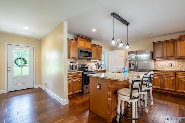 915 County Road 349, Leesburg, AL 35983 - kitchen featuring brown cabinets, backsplash, appliances with stainless steel finishes, and a sink