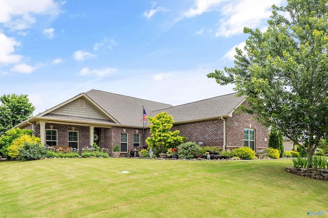 7417 Nature Walk Way SE, Owens Cross Roads, AL 35763 - view of front of house with brick siding, a front yard, and roof with shingles