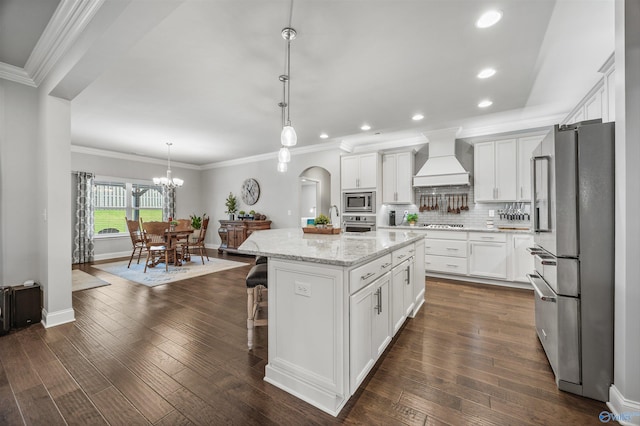 7417 Nature Walk Way SE, Owens Cross Roads, AL 35763 - kitchen with stainless steel appliances, custom exhaust hood, a kitchen island, white cabinetry, and recessed lighting