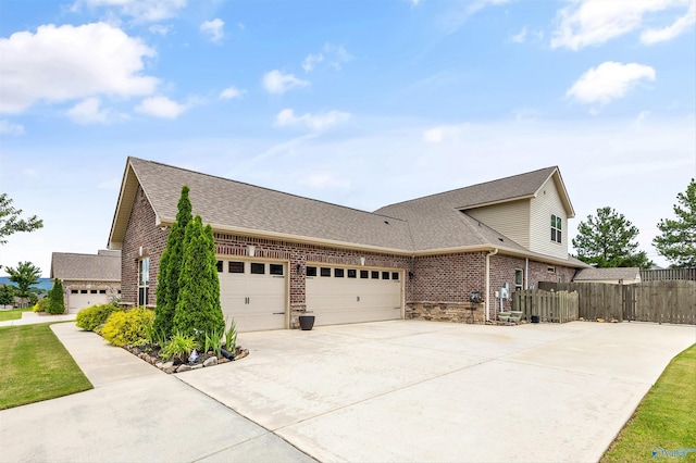 7417 Nature Walk Way SE, Owens Cross Roads, AL 35763 - view of home's exterior with brick siding, an attached garage, driveway, and roof with shingles