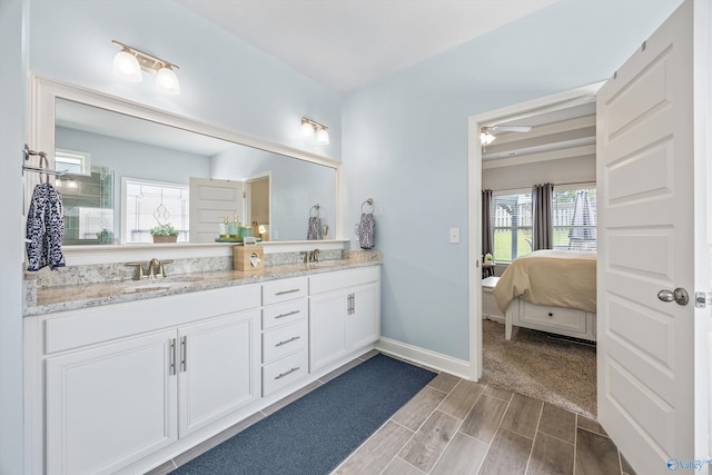 7417 Nature Walk Way SE, Owens Cross Roads, AL 35763 - ensuite bathroom featuring double vanity, wood finish floors, baseboards, and a ceiling fan