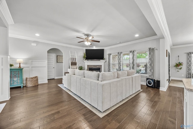 7417 Nature Walk Way SE, Owens Cross Roads, AL 35763 - living area with ceiling fan, a fireplace, arched walkways, recessed lighting, and dark wood-type flooring