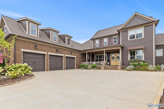 view of front of home with a porch and a garage