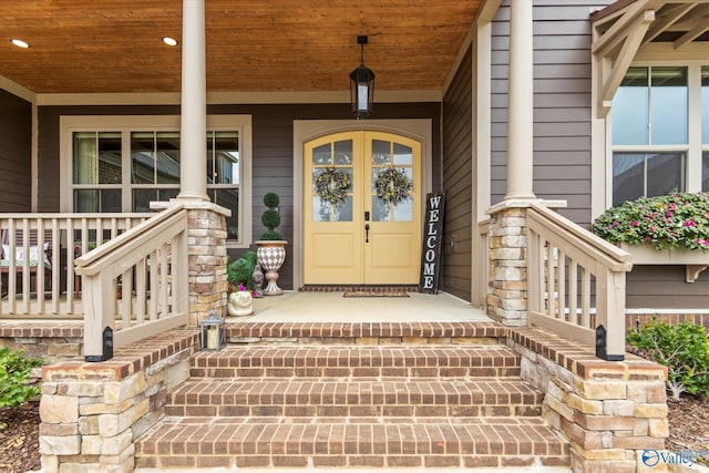 view of exterior entry featuring covered porch