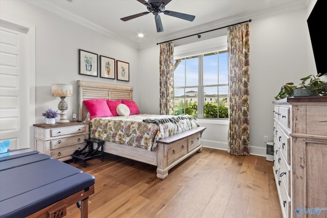 bedroom featuring light hardwood / wood-style flooring, ceiling fan, and crown molding