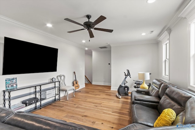 living room with ceiling fan, light wood-type flooring, and ornamental molding