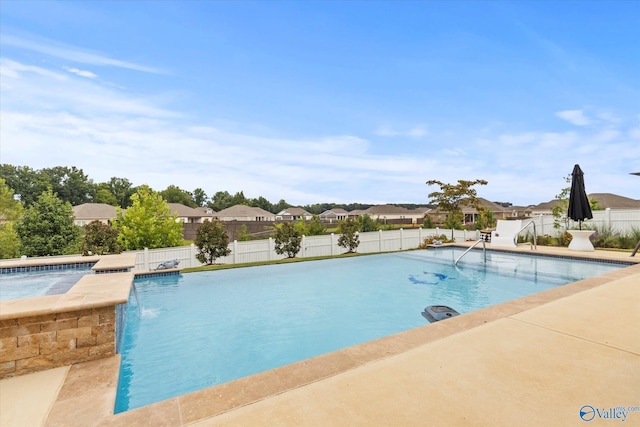 view of pool featuring pool water feature and a patio area