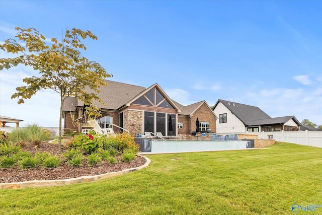 rear view of house with a yard