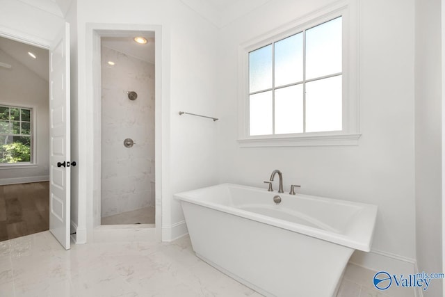 bathroom featuring shower with separate bathtub and vaulted ceiling