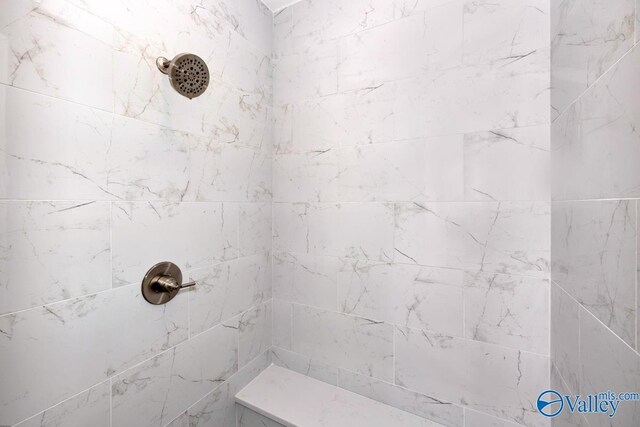 bathroom with a tile shower