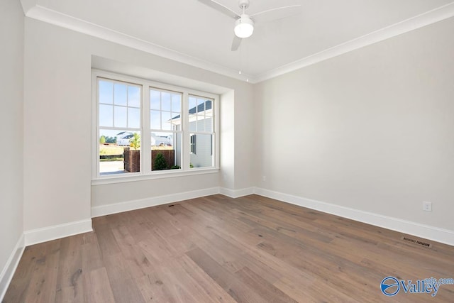 unfurnished room with hardwood / wood-style floors, crown molding, and ceiling fan