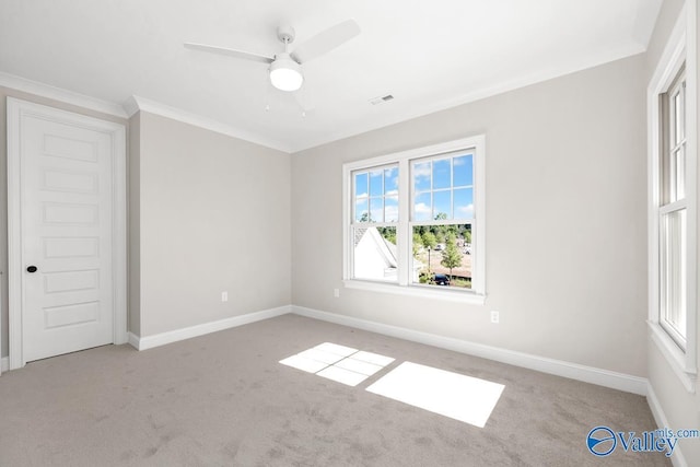 unfurnished room with ceiling fan, light colored carpet, and ornamental molding