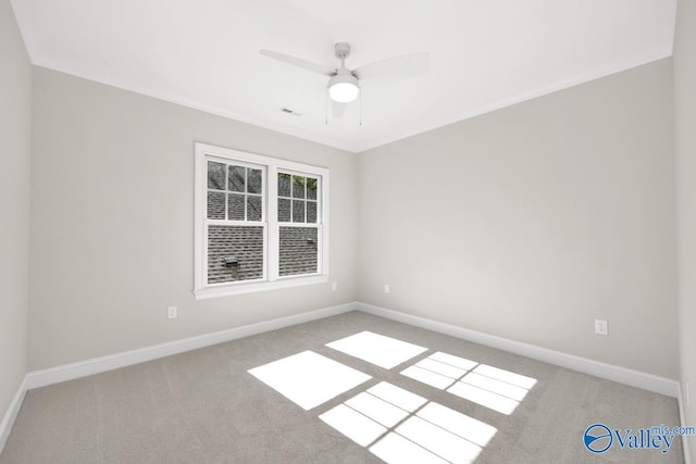 carpeted spare room with ceiling fan