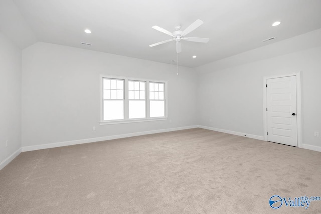 unfurnished room featuring lofted ceiling, light carpet, and ceiling fan