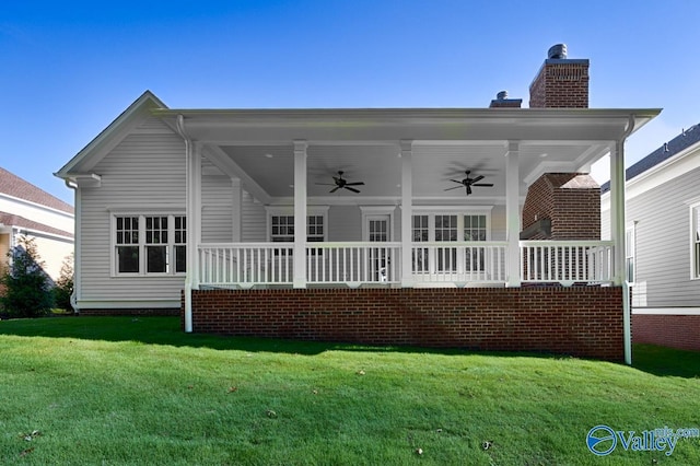 back of house featuring a lawn, ceiling fan, and a porch