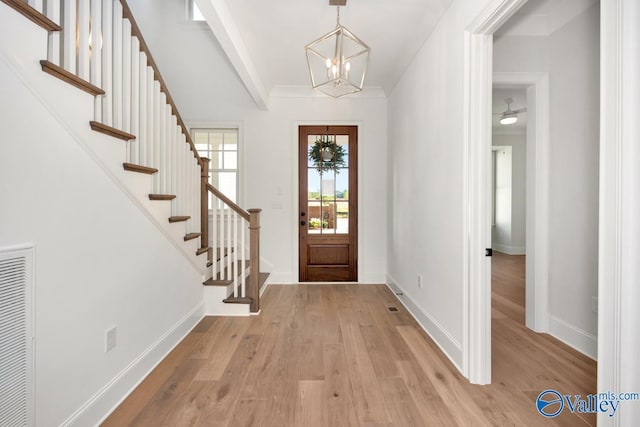 foyer with an inviting chandelier and light hardwood / wood-style floors