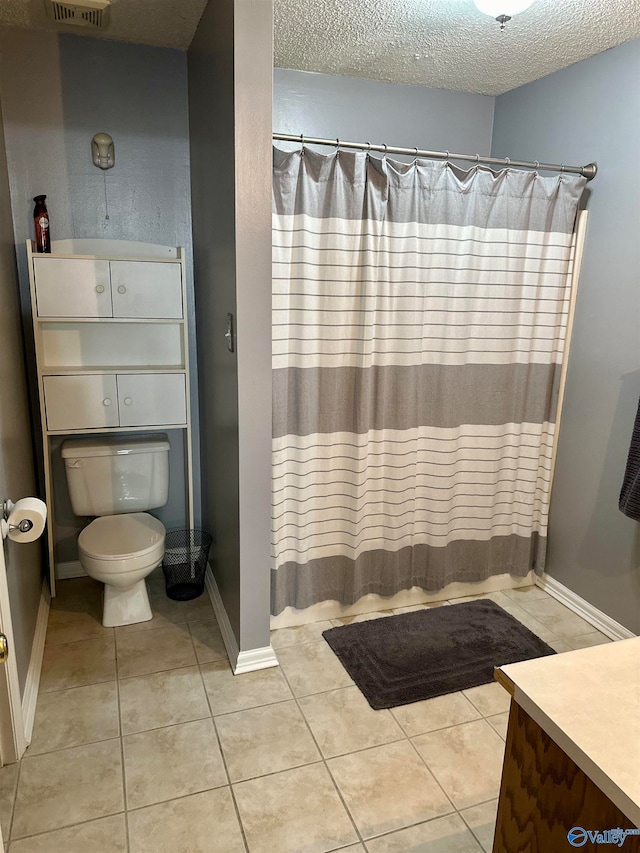 bathroom featuring tile patterned flooring, vanity, curtained shower, and a textured ceiling