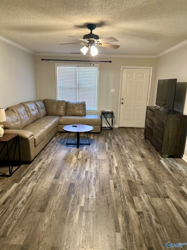 living room with wood-type flooring, a textured ceiling, ceiling fan, and crown molding