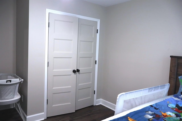 bedroom featuring dark hardwood / wood-style floors and a closet