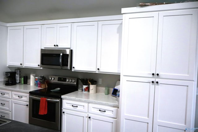 kitchen with stainless steel appliances and white cabinets