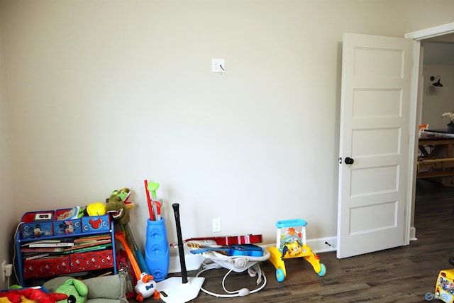 recreation room with dark hardwood / wood-style floors