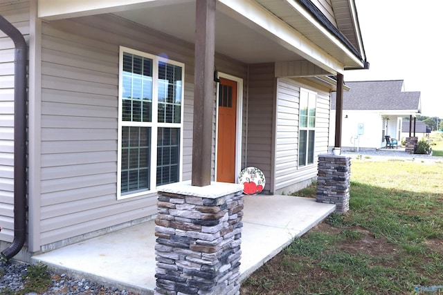 view of exterior entry with a yard