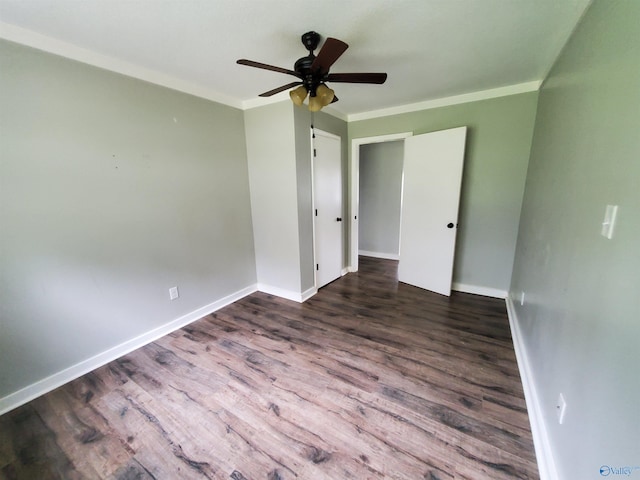 empty room featuring dark hardwood / wood-style floors, ceiling fan, and ornamental molding