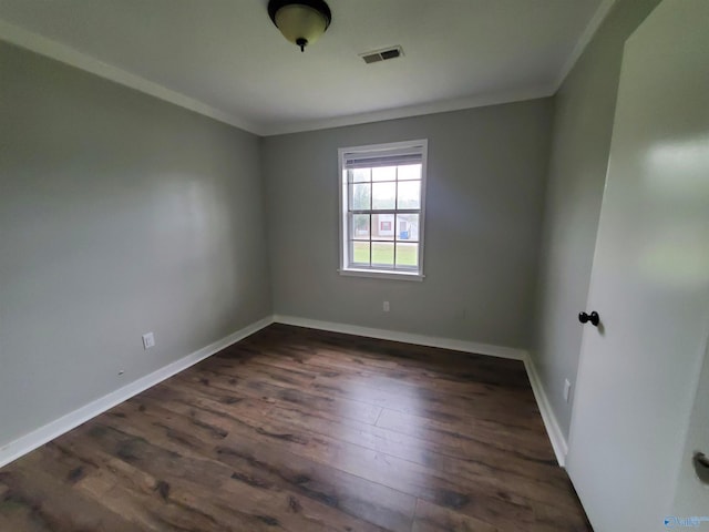 unfurnished room with dark wood-type flooring and ornamental molding