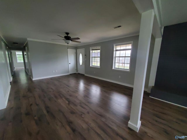 unfurnished living room featuring crown molding, ceiling fan, and dark wood-type flooring