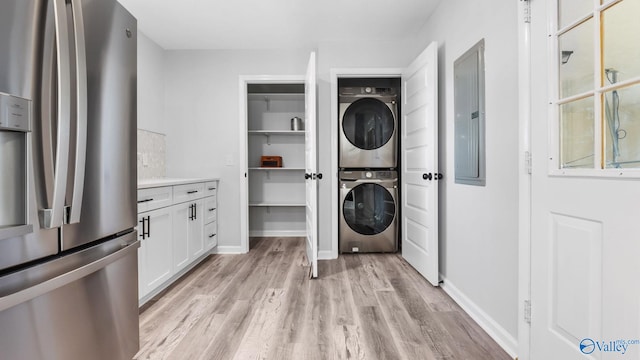 2055 Big Nose Dr, Centre, AL 35960 - washroom with stacked washer and clothes dryer, light wood finished floors, and baseboards