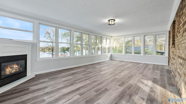 unfurnished sunroom featuring a fireplace