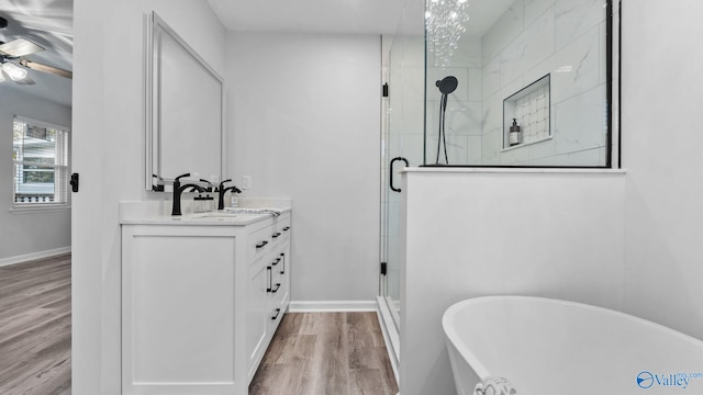 2055 Big Nose Dr, Centre, AL 35960 - bathroom with vanity, a stall shower, a freestanding bath, wood finished floors, and a ceiling fan