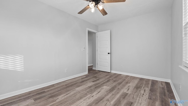 empty room with ceiling fan and wood-type flooring