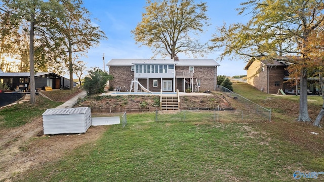 rear view of house featuring a lawn