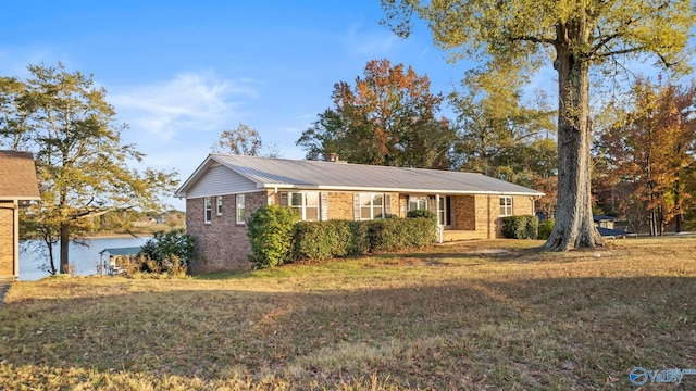 single story home featuring a front yard and a water view