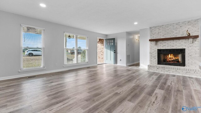2055 Big Nose Dr, Centre, AL 35960 - unfurnished living room with baseboards, a fireplace, healthy amount of natural light, and recessed lighting