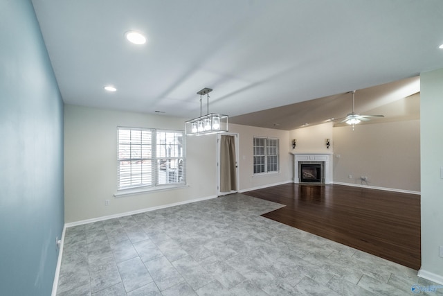 unfurnished living room with light wood-type flooring, ceiling fan, and lofted ceiling