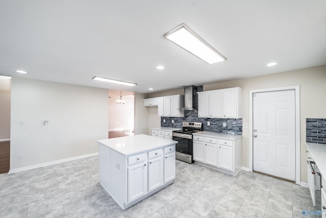 kitchen with wall chimney range hood, a kitchen island, tasteful backsplash, stainless steel electric range, and white cabinets