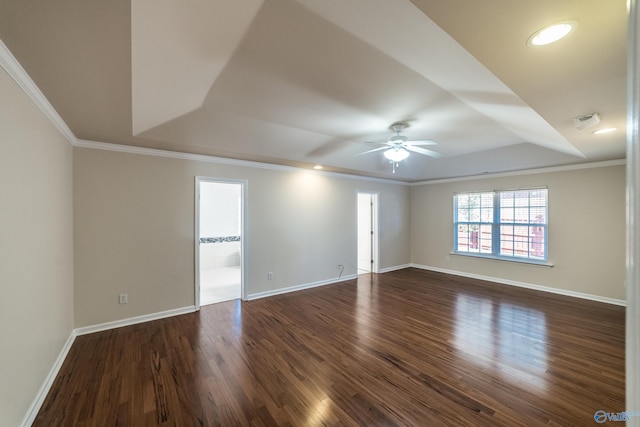 unfurnished room with dark hardwood / wood-style floors, ceiling fan, crown molding, and a tray ceiling