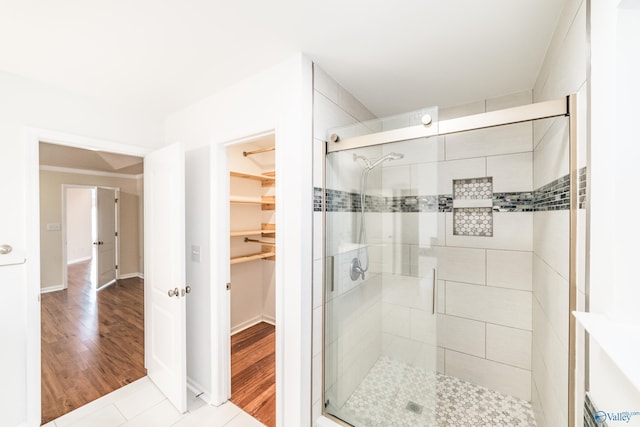 bathroom with hardwood / wood-style floors and walk in shower