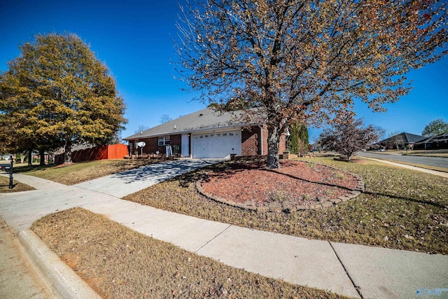 single story home featuring a garage and a front lawn