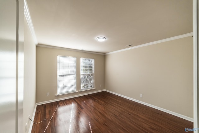 spare room with ornamental molding and dark wood-type flooring