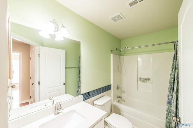 full bathroom featuring a chandelier, shower / bath combo, vanity, and toilet