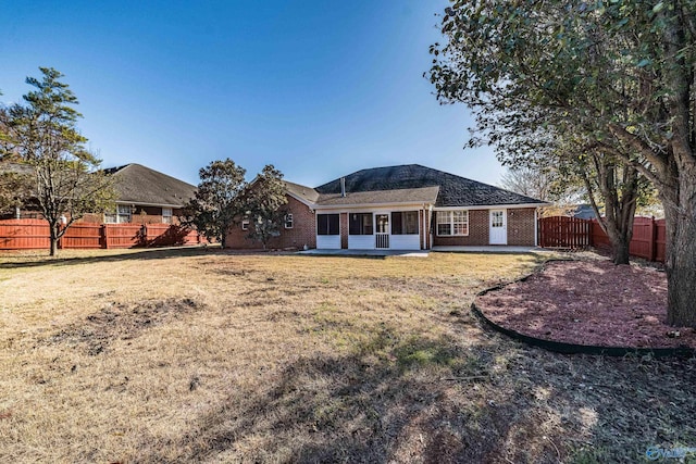 rear view of property with a lawn and a patio area